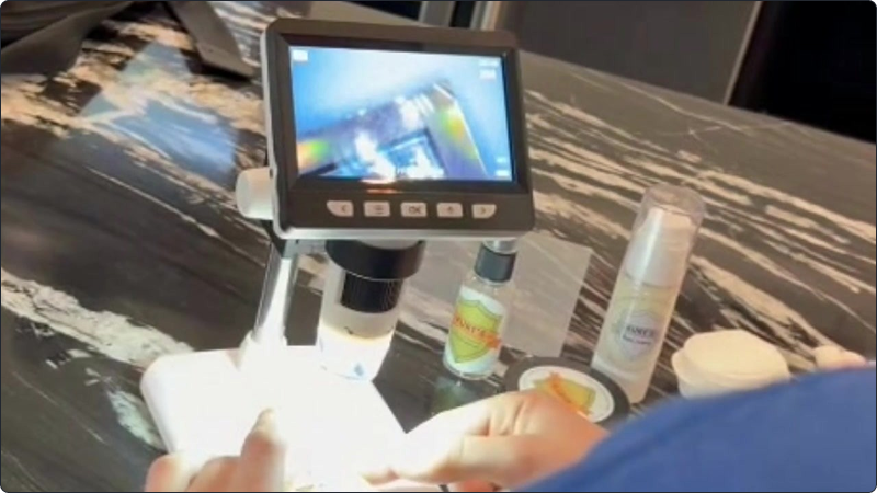 Matthew checks a card under a digital microscope in The Card Wash video.